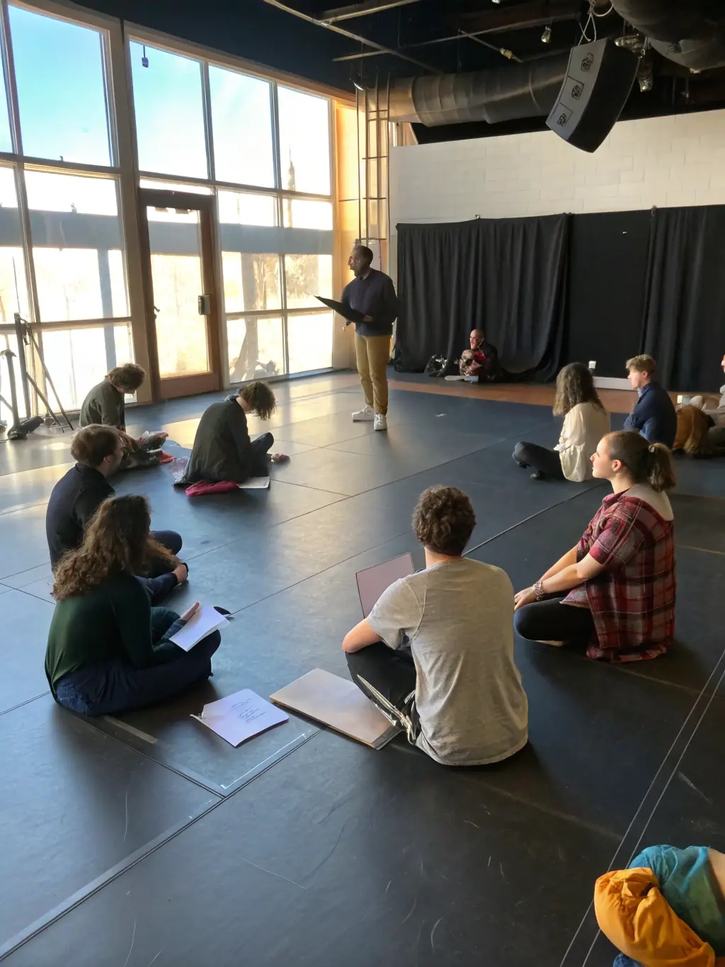 A photograph of a rehearsal session, capturing the dedication and collaborative spirit of the performers and creative team working on a new production.