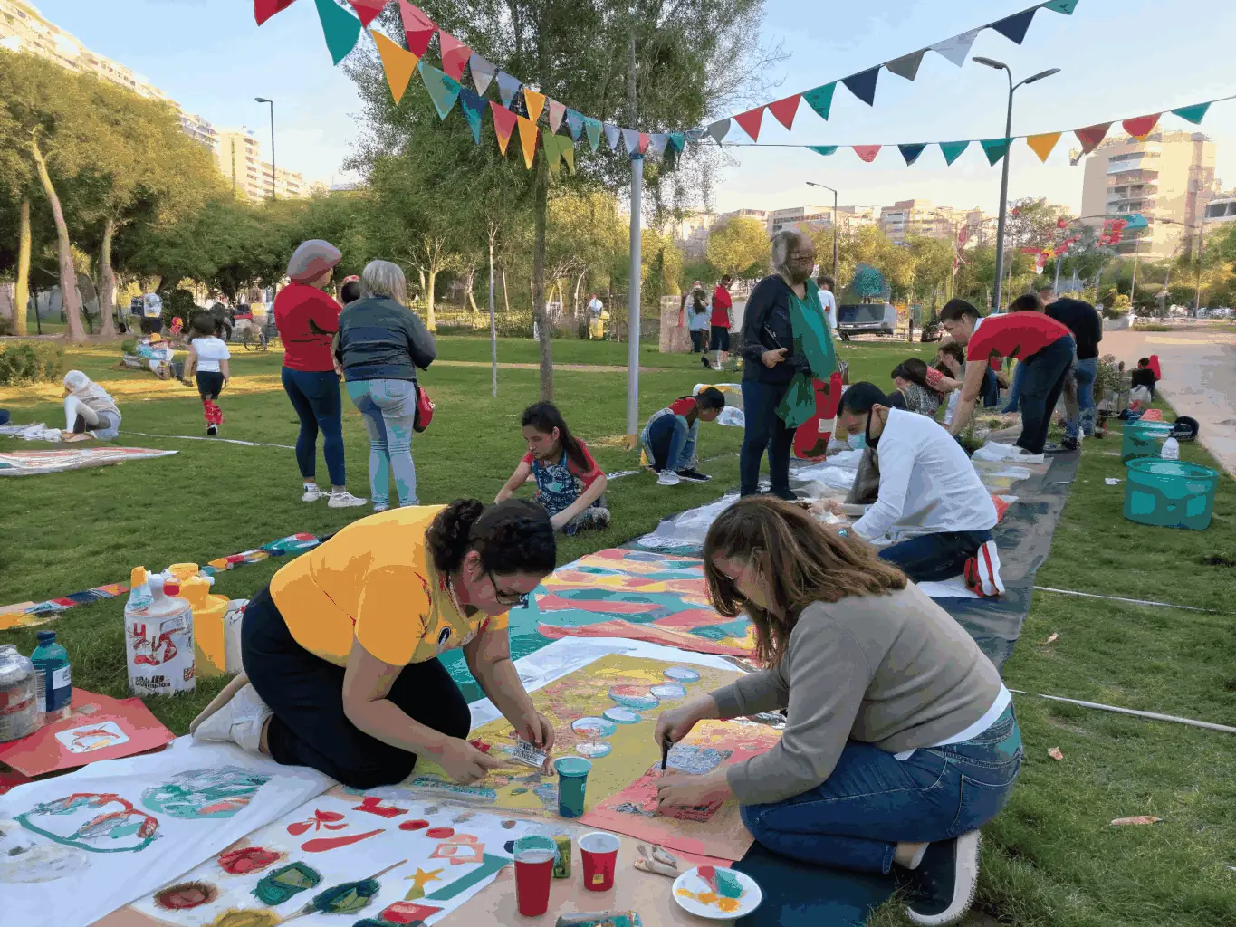 A heartwarming image showing community members of various ages participating in an interactive arts event organized by ARMO CIE JEROME THOMAS, emphasizing the organization's commitment to audience engagement.